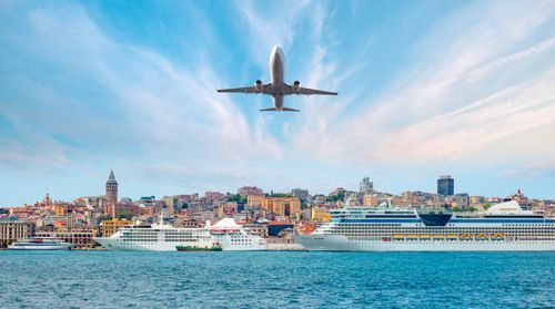 Airplane flying over Istanbul city - Luxury cruise ship in Bosporus against istanbul city with full moon - istanbul, Turkey