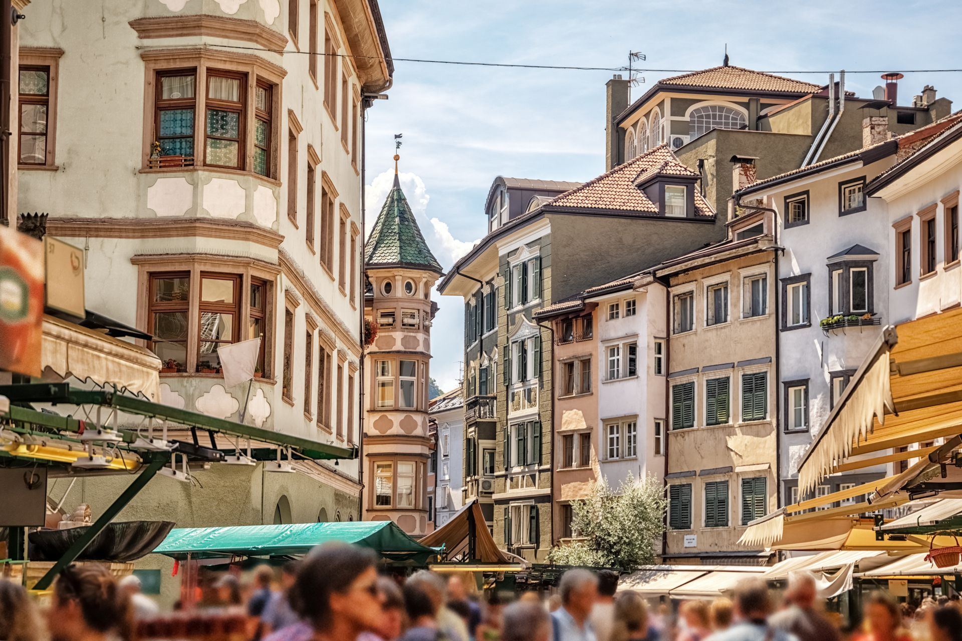 Market stands on the crossing of Via dei Portici / Piazza delle Erbe in Bolzano, South Tyrol, Italy